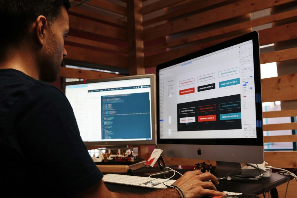 man using 2 Apple computers