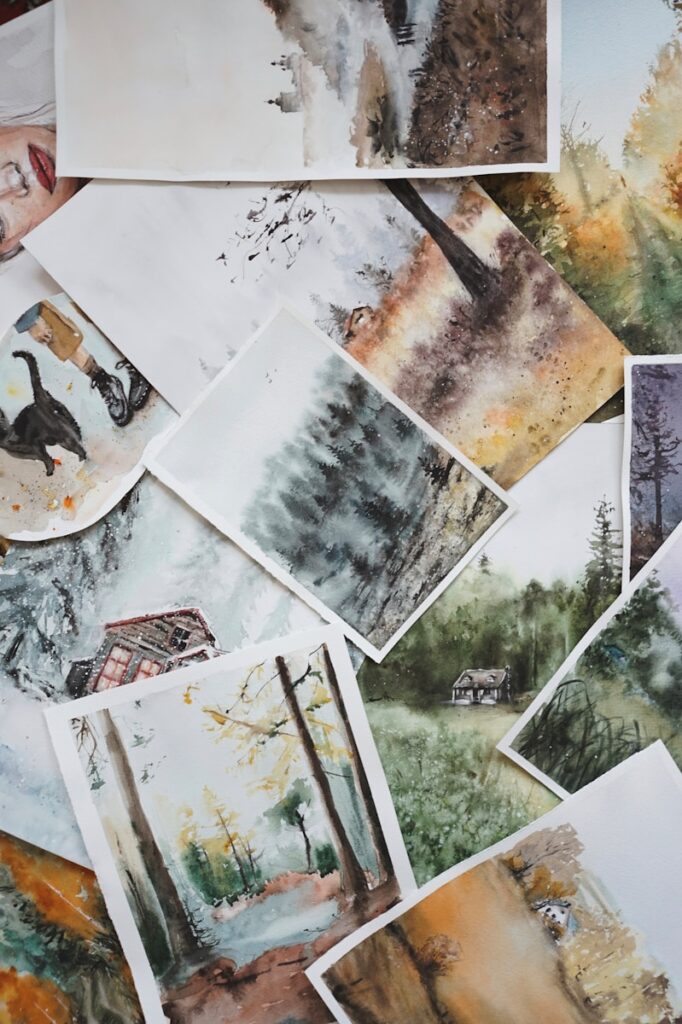 different photos of nature, animals, people, drawn and laid on table